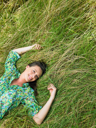 Woman laying down in a fieldの写真素材