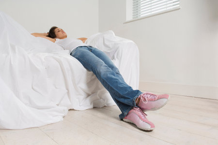 Woman resting on couch in new home