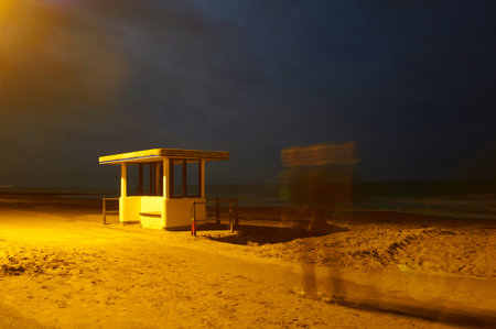 Time lapse view of man on beach at nightの写真素材