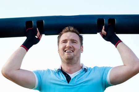 Man lifting weights outdoors
