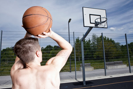 Man playing basketball on urban courtの写真素材