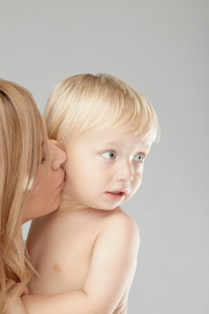 Mother kissing baby boys cheekの写真素材