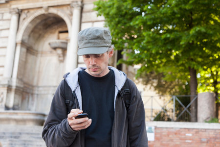 Man using cell phone on city streetの写真素材