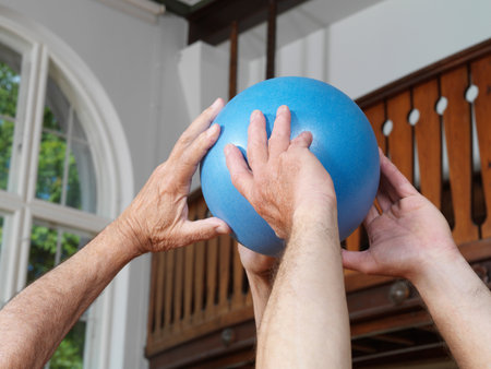 Close up of men passing rubber ballの写真素材