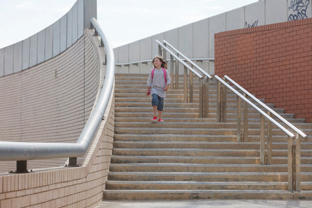 Girl climbing stairs outdoorsの写真素材