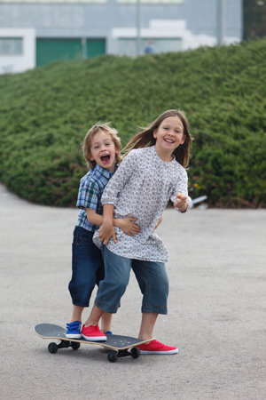 Children playing on skateboardの写真素材
