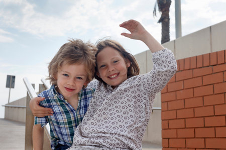 Children sliding down banister on steps