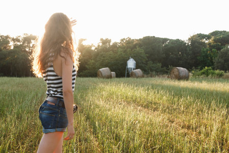 Woman standing in grassy fieldの写真素材