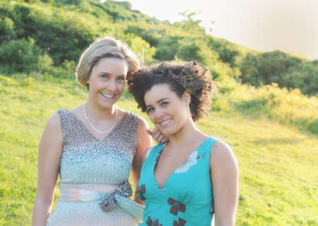 Smiling women standing in meadowの写真素材