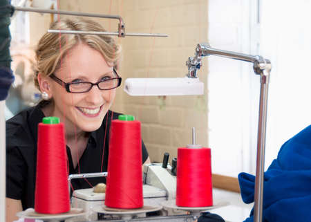 Worker sewing fabric in garment factory