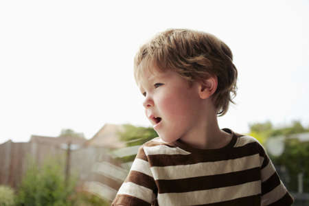 Boy sitting at windowの写真素材