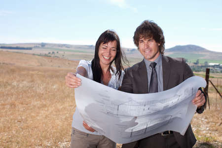 Business people reading blueprints