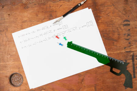Gun shaped ruler and pen on paperの写真素材