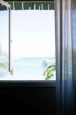 Ocean view from open windowの写真素材
