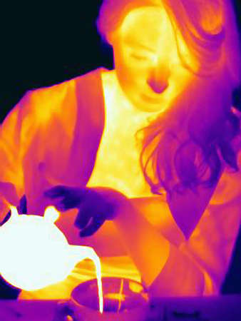 Thermal image of woman having cup of teaの写真素材