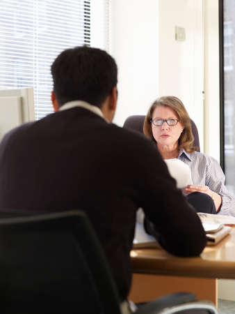 Business people talking at deskの写真素材