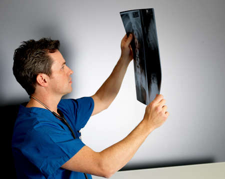 Nurse examining x-rays in hospital