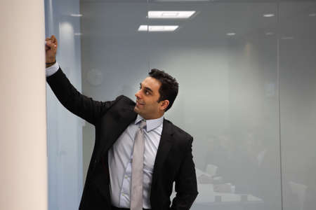 Businessman writing on whiteboard
