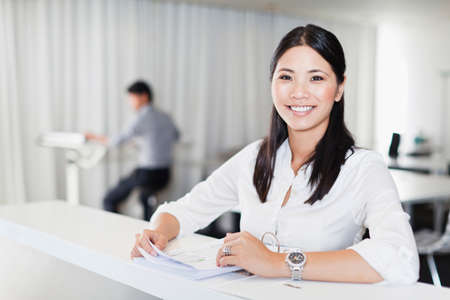 Businesswoman smiling at deskの写真素材