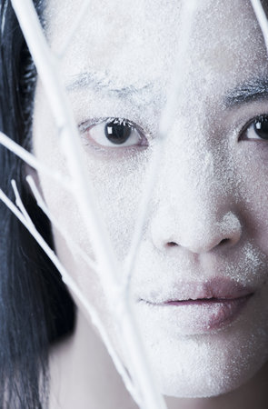 Woman?s face covered in powderの写真素材