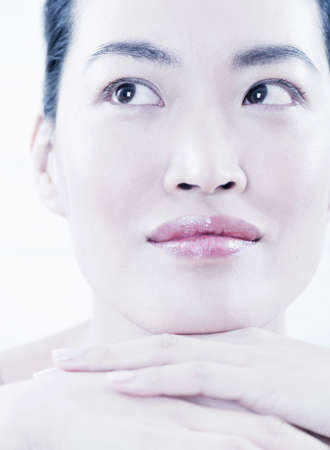 Close up of woman resting chin in handsの写真素材