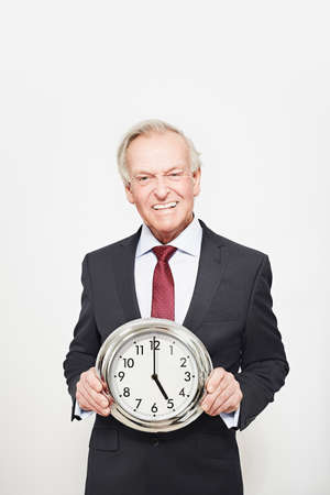 Businessman holding clockの写真素材