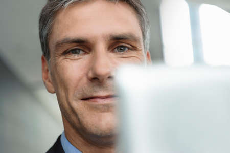 Mature businessman using digital tabletの写真素材