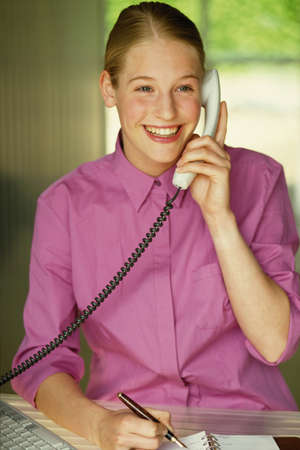 Girl using telephoneの写真素材