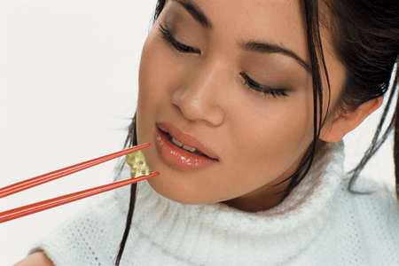 Young woman eating sweetsの写真素材