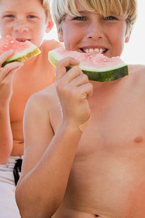 Boys eating watermelonの写真素材
