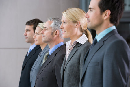 Five businesspeople in a rowの写真素材