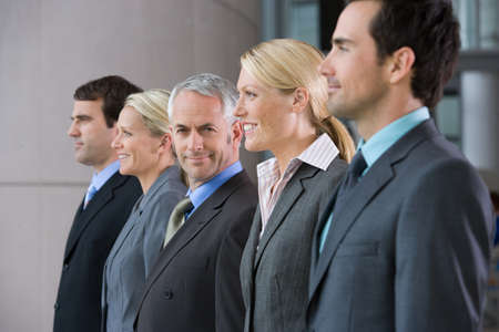 Five businesspeople in a rowの写真素材