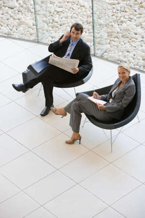 Two business colleagues in armchairsの写真素材