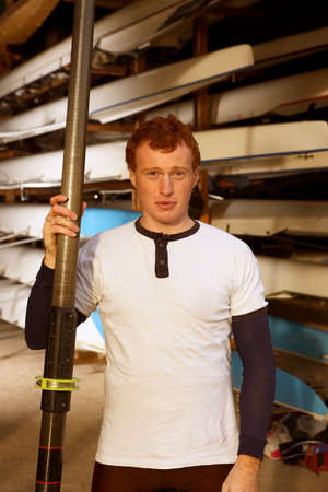 Oarsman outside boat shed