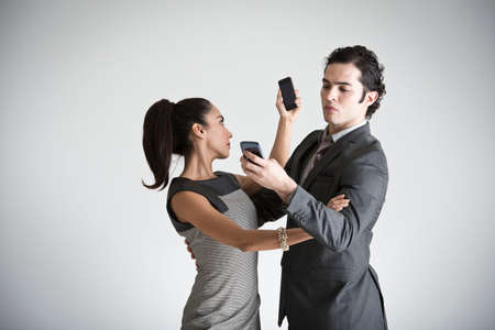 Business couple using smartphonesの写真素材