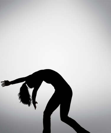 Silhouette of woman dancingの写真素材