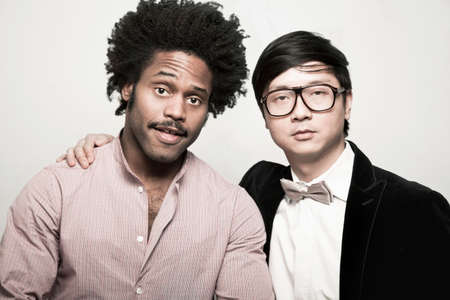 Portrait of man with afro and man wearing bow tie