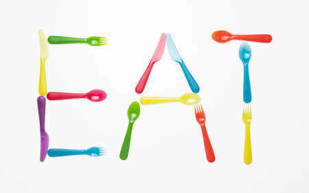 EAT written in plastic cutleryの写真素材