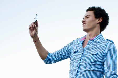 Young man taking a picture of himselfの写真素材