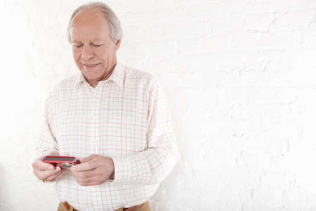 Senior man holding digital camera
