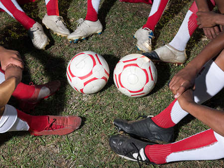 Footballs and legs of footballersの写真素材