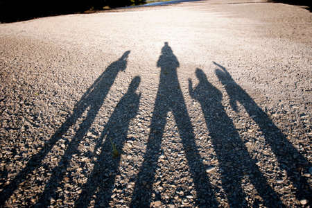 Shadow of family on ground