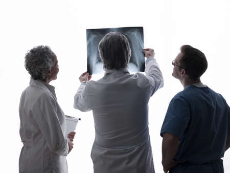 Doctors and surgeon looking at x-rayの写真素材