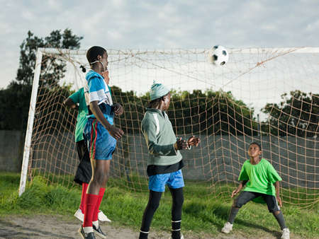 Teenage boys playing football