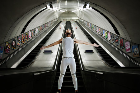 Olympic competitor standing at bottom of escalatorsの写真素材