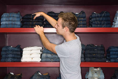 Man shopping for a pair of jeansの写真素材