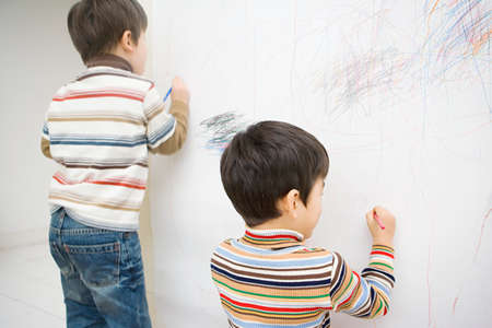 Boys drawing on a wallの写真素材
