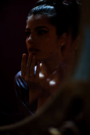 Anxious woman in dark shadows