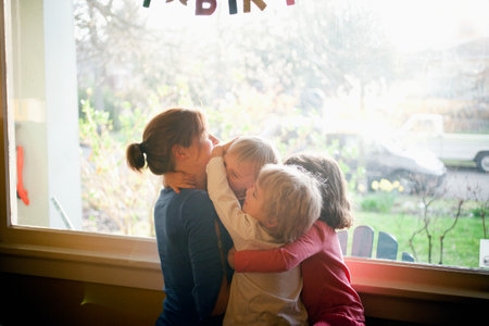 Mother embracing three childrenの写真素材