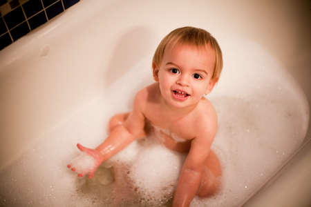 Toddler boy having a bath